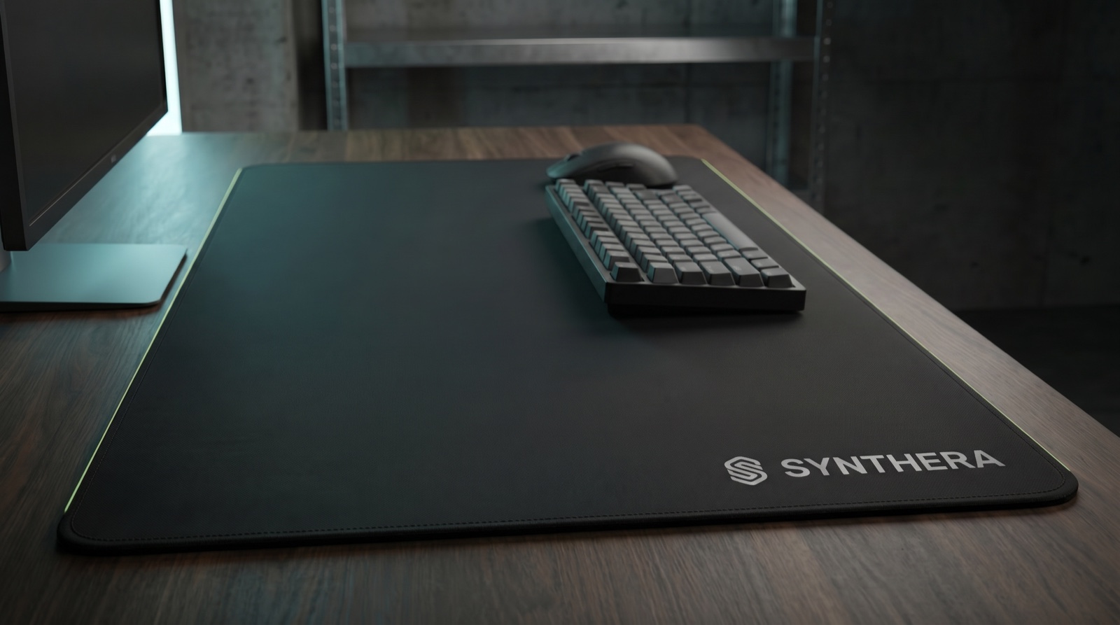 Synthera deskmat — corner lockup on a dev desk